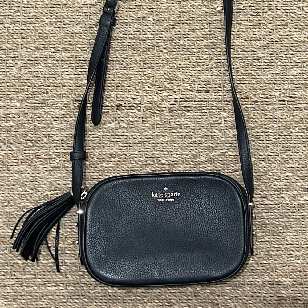 Small black leather Kate Spade cross-body bag with zipper tassel.